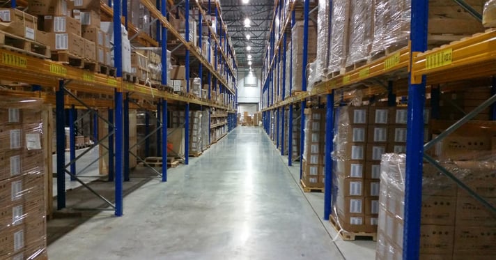 Something like "Warehouse aisle with stacked pallets and packaging