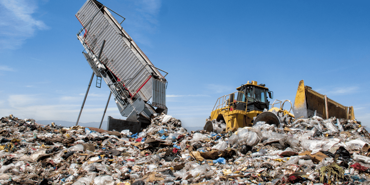 Landfill operations with dump truck and bulldozer managing waste, illustrating rising disposal costs in Orange County